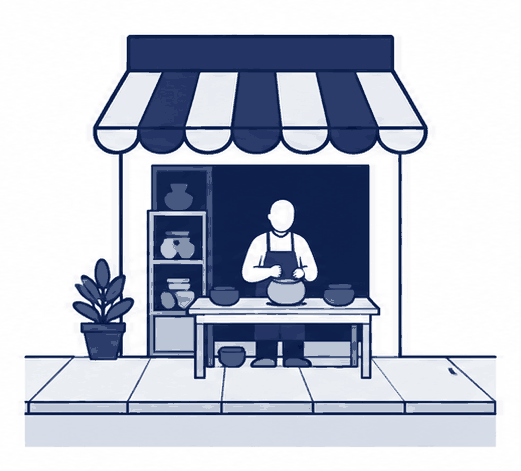 店が1軒だけの通り。店主がひとり、店先で何かをつくっている